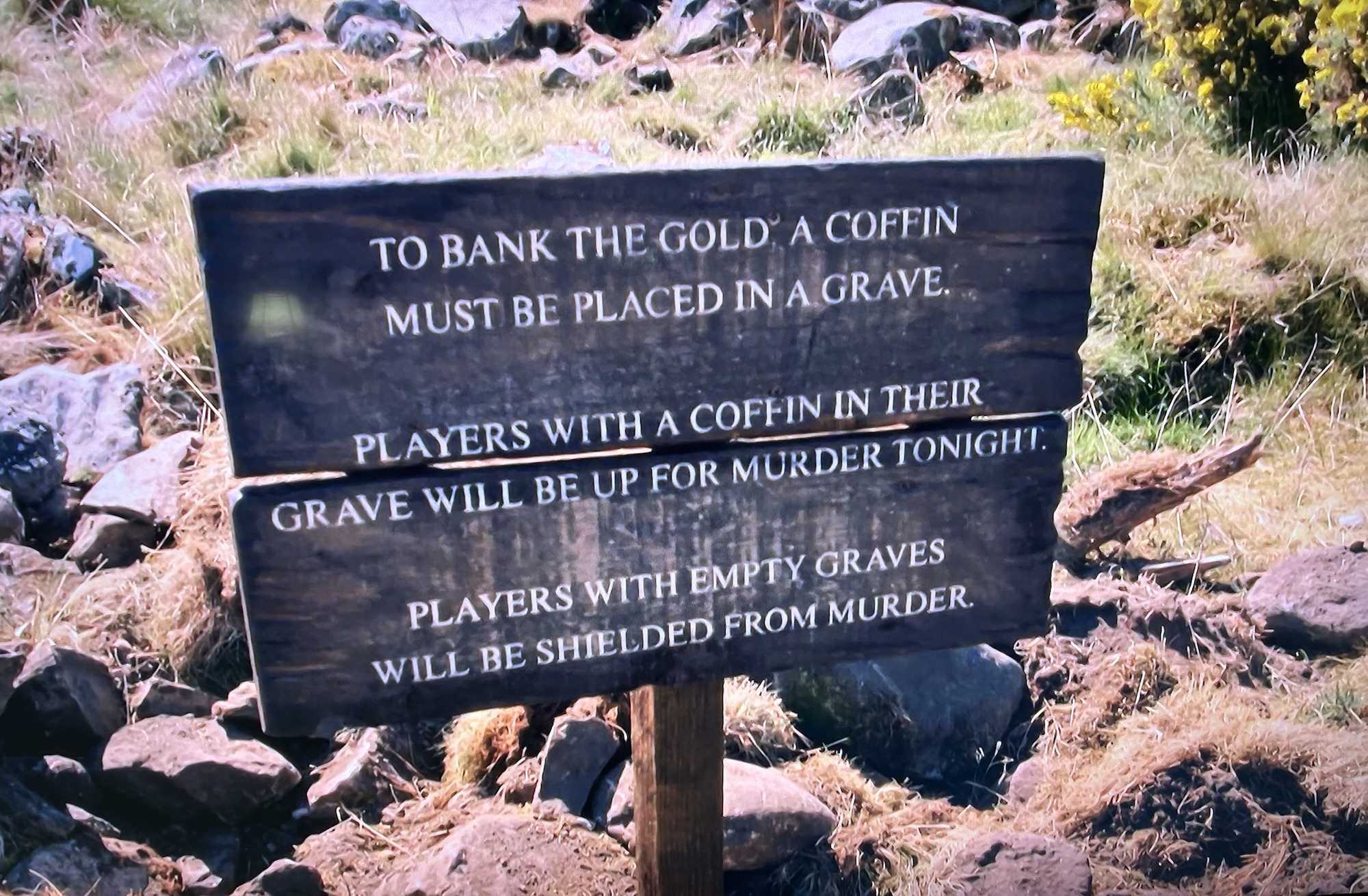 A wooden sign that states, to bank the coffin must be placed in a grave. Players with a coffin in their grave will be up for murder tonight. Players with empty graves will be shielded from murder.